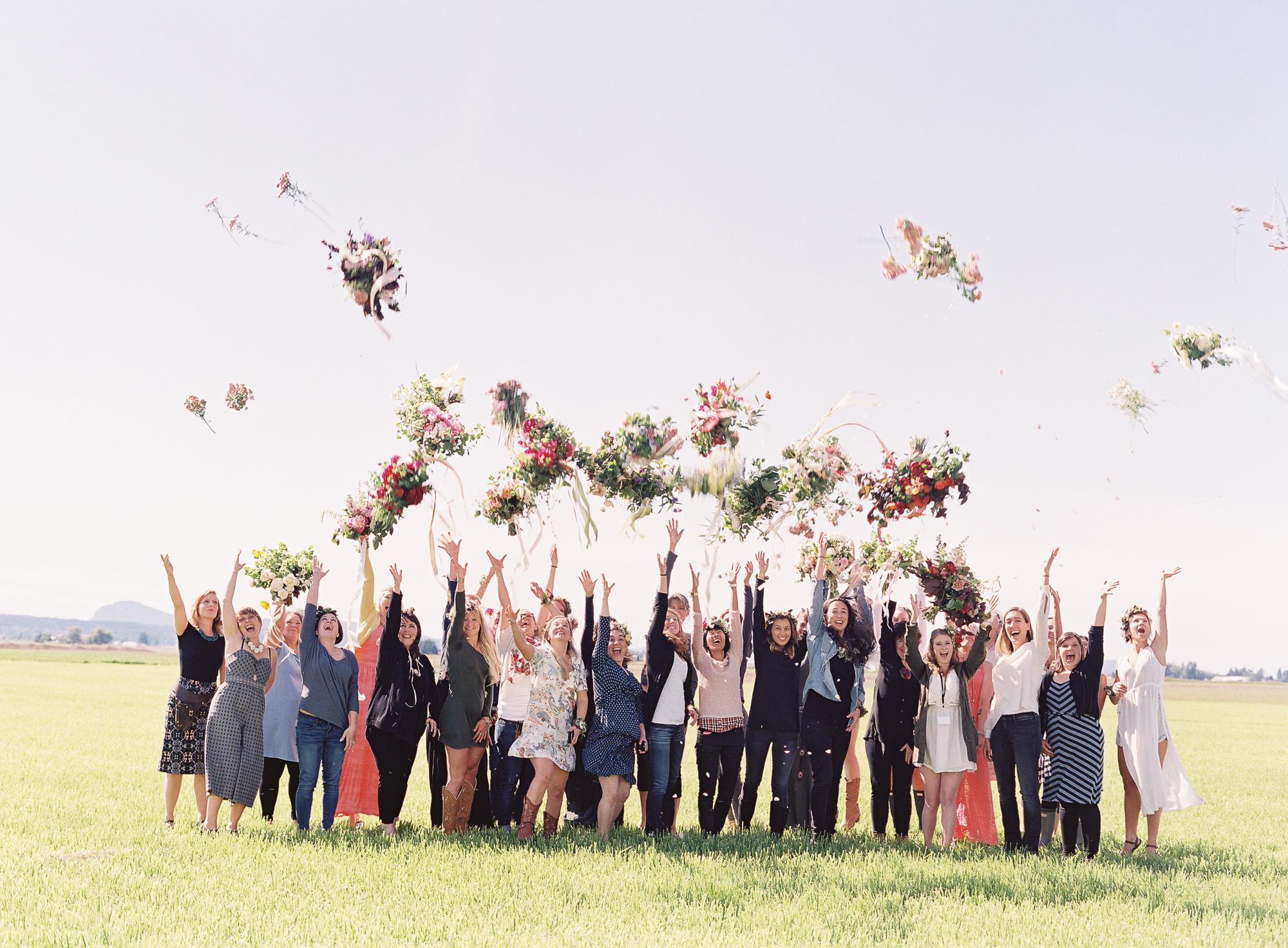 Floret workshop participants throwing bouquets in the air